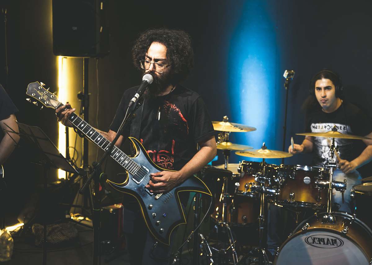 leisure activities man in black shirt playing electric guitar musical instrument